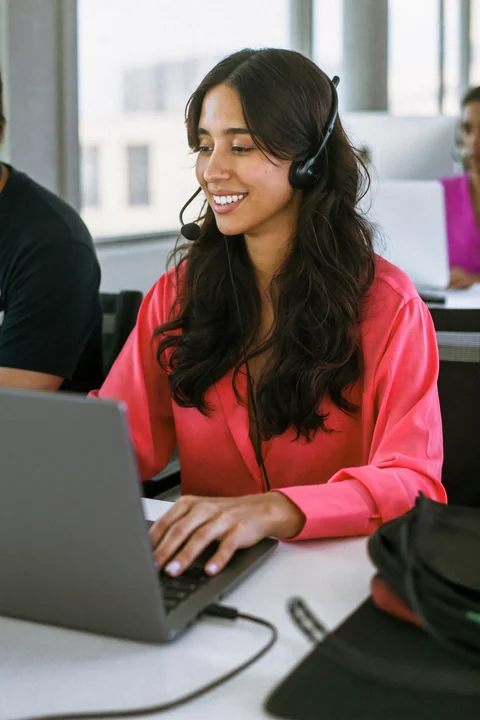 Support agent with a headset talking to a caller